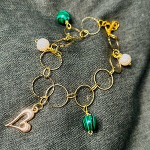 Stunning gold color bracelet with heart charm, gold and green beads